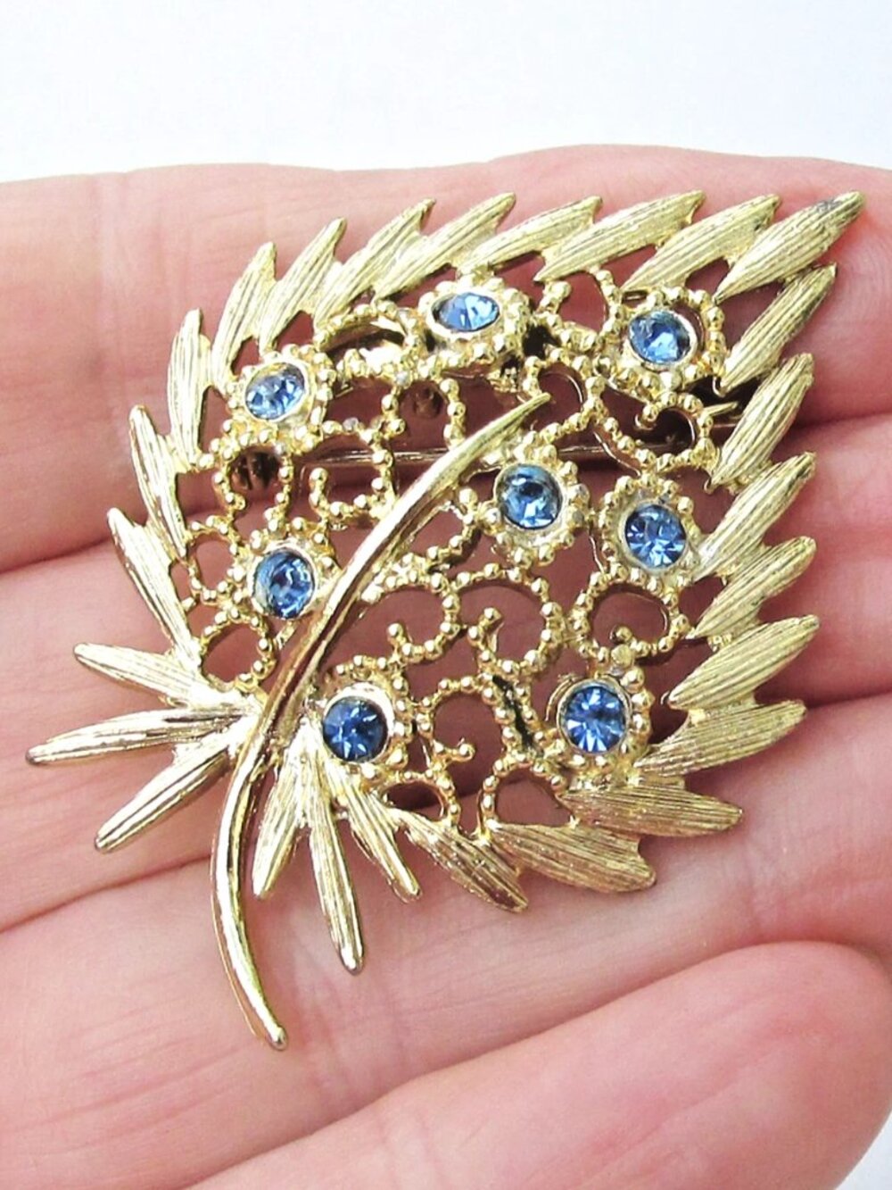 Vintage Mid-Century Blue Rhinestone Gold Tone Open Work Curved LEAF Brooch Pin